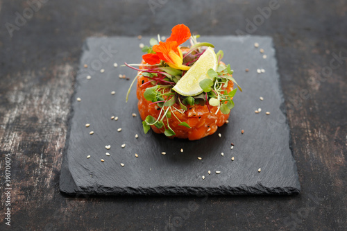 Salmon tartare with edible florals. A light appetizing appetizer