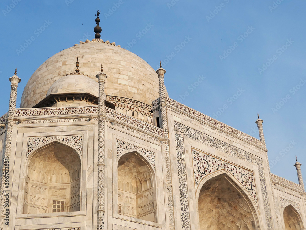 India - Uttar Pradesh - Agra - Taj Mahal - A Different Angle - A different angle with a warm sunshine yellow glow, highlighting the white marble onion dome with its finial, guldastas and arches.
