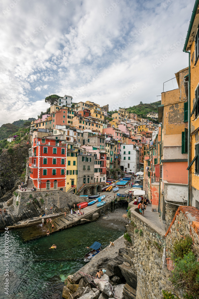 Cloudy day in Riomaggiore, panoramic landscapes of Riomaggiore with its cliff and port beside the sea