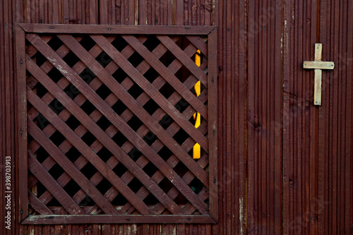 A Catholic wooden confession booth, empty, in close range, old one. Religion concept