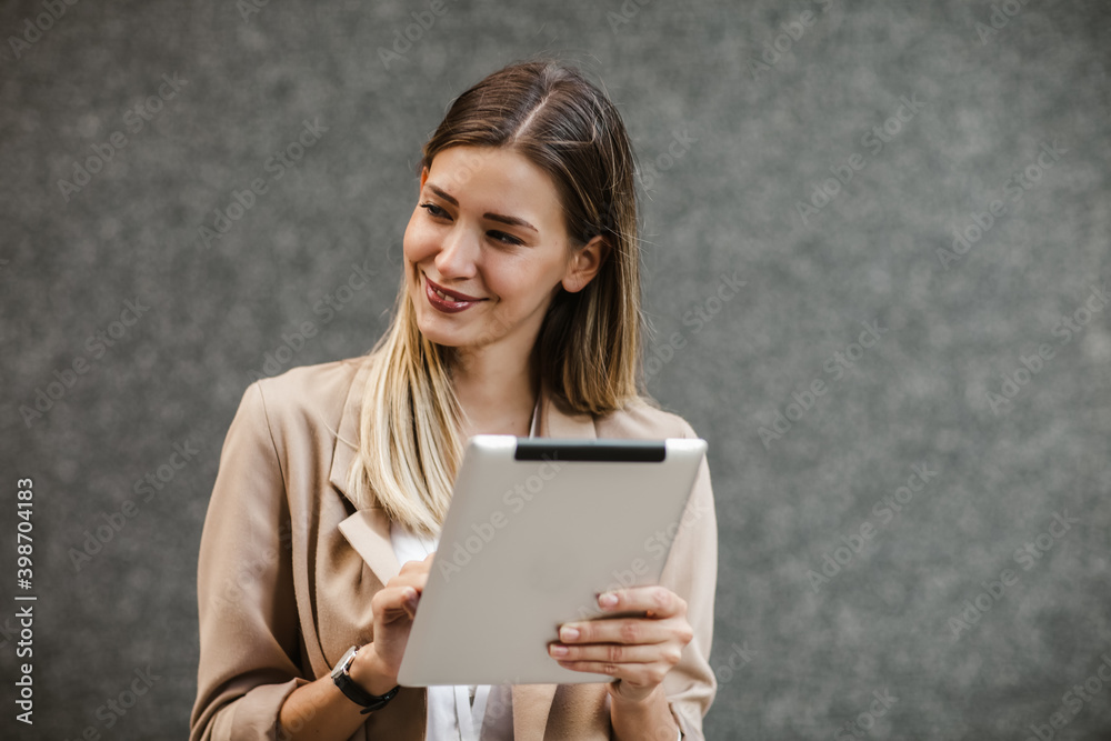 Portrait of successful businesswoman holding digital tablet Portrait of successful businesswoman holding digital tablet
