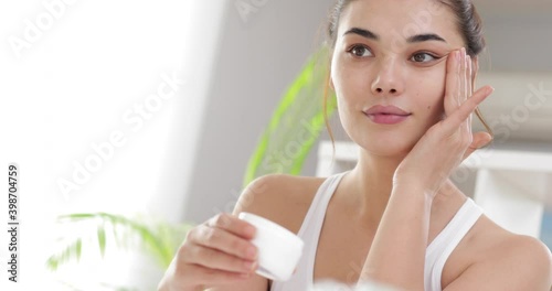 woman applying makeup on her face