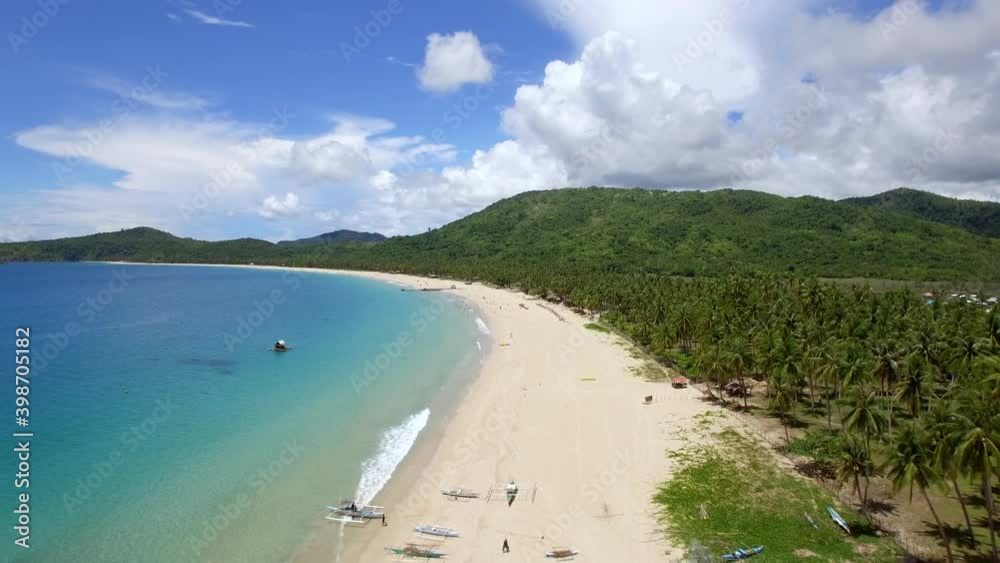Aerial view of palm trees and turquoise ocean water at Nacpan Beach in El Nido, Palawan Island, Philippines. Aerial view of palm trees and turquoise ocean water at Nacpan Beach in El Nido, Palawan Island, Philippines.