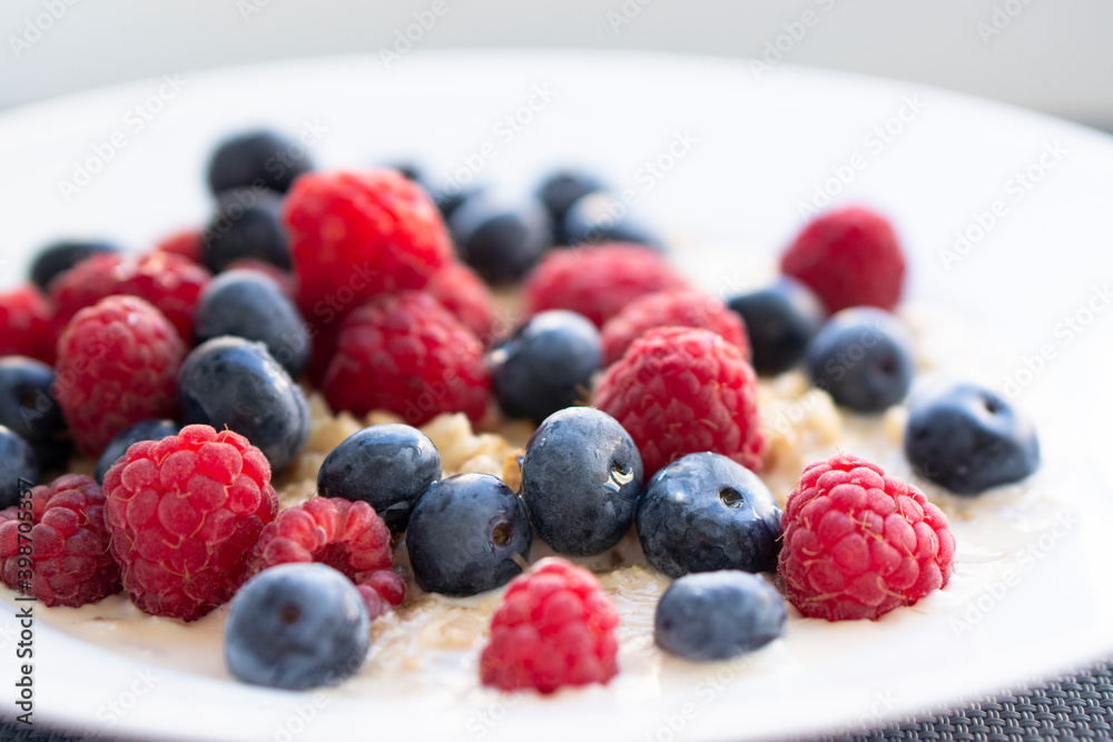 Tasty oatmeal with berries for breakfast, close-up, top view, horizontal