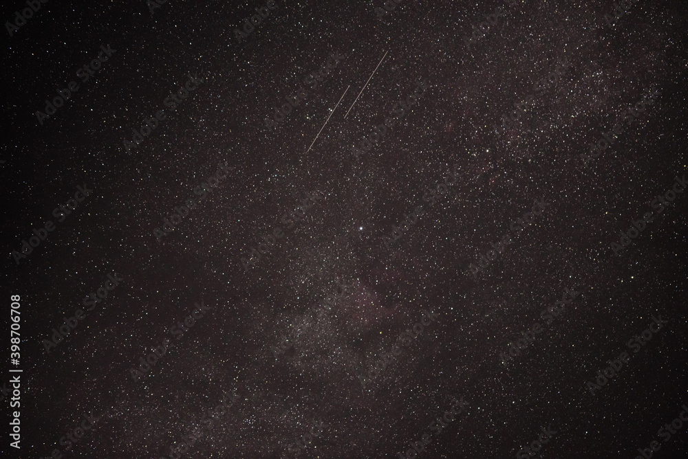 starlink satellites near the milky way galaxy on the dark summer sky - obrazy, fototapety, plakaty 