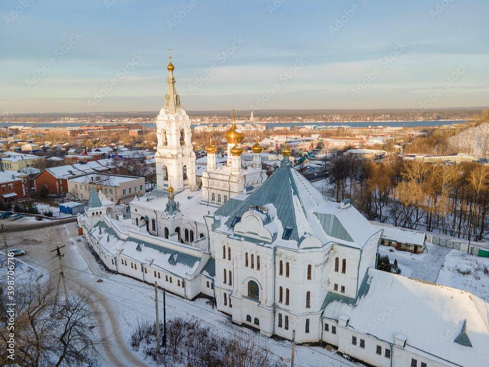 Aerial view of old monastery for men in Russia, Perm city in winter sunny day, golden dome