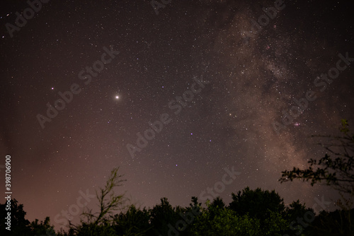 planets Jupiter and Saturn on summer night sky of 2020 with milky way galaxy shining trough milions of stars 