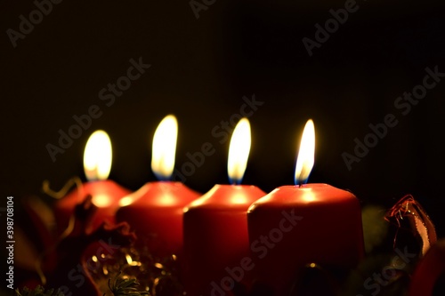 close up of an Advent arrangement with four burning candles
