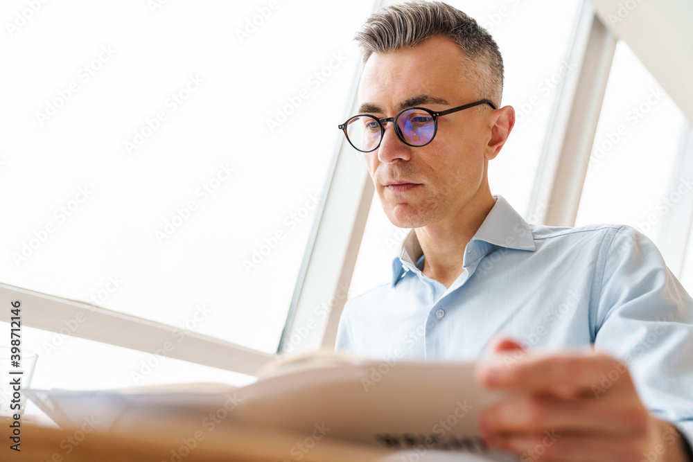 Handsome man working with documents in cafe Handsome man working with documents in cafe