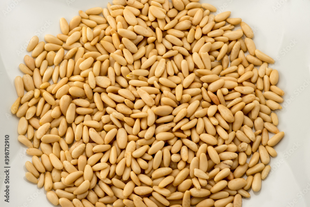 pine nuts, heap of seeds isolated on white background in top view pine nuts, heap of seeds isolated on white background in top view
