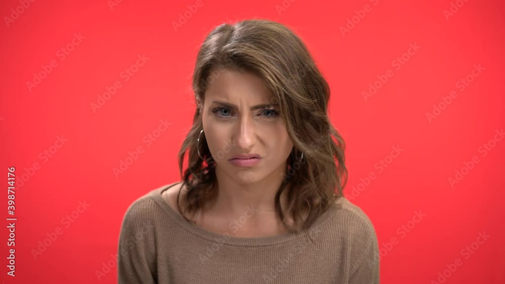 Disgusted woman shakes head no and grimaces in studio