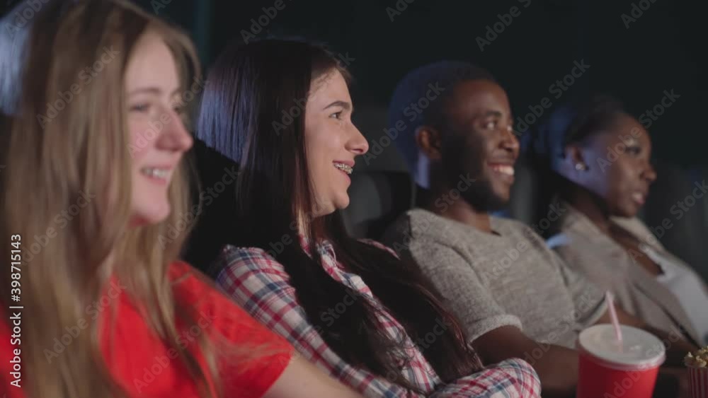 Emotional girl watching comedy in cinema. Emotional girl watching comedy in cinema.