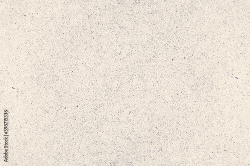 Worn and rough beige background with dots and specks of dust. Grunge texture of antique cardboard