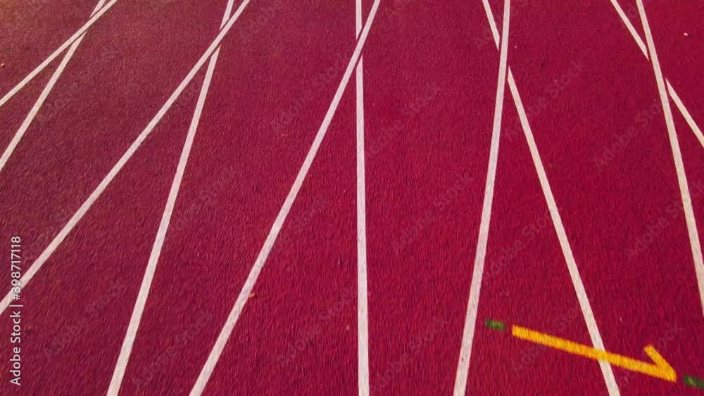Aerial footage of running track in a sport stadium. first person view of a runner in a competition. Victory at the finishing line.