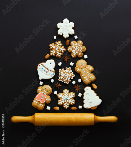 Christmas cookies in the shape of a Christmas tree on the blue background. Top view. photo