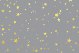 Illuminating gold stars confetti on Ultimate Gray background. Color year 2021. Golden sparkles holiday backdrop. Flat lay.