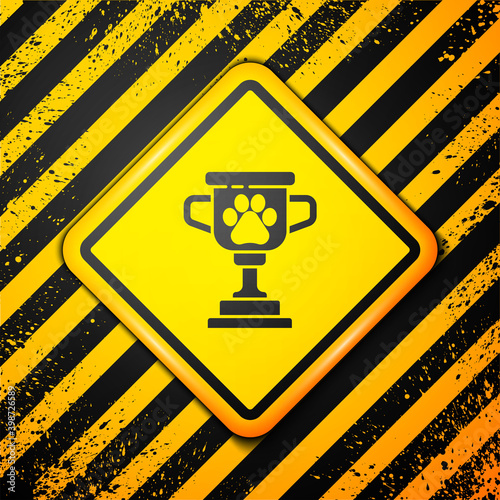 Black Pet award symbol icon isolated on yellow background. Medal with dog footprint as pets exhibition winner concept. Warning sign. Vector.
