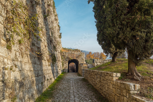way in the Medieval castle of the city Brescia on a sunny clear day against a bright blue sky. Part of Brescia castle on the hill Cidneo. view on the arch. Castello di Brescia, Lombardy, Italy. photo