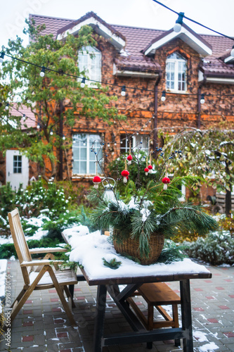 yard of a country house with New Year's decoration covered with snow © andrey