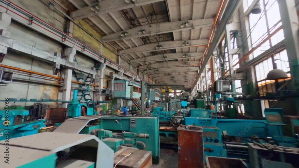 Aerial view flying low, over machinery an old car manufactory hall - FPV, drone shot Aerial view flying low, over machinery an old car manufactory hall - FPV, drone shot