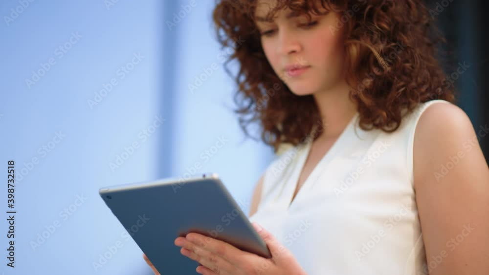 Charming girl surfing internet on tablet. Beautiful lady using device outside. Charming girl surfing internet on tablet. Beautiful lady using device outside.