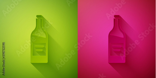 Paper cut Bottle of wine icon isolated on green and pink background. Paper art style. Vector.