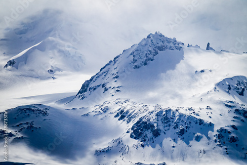 Dramatic snow capped mountain peaks of Elephant Island off the coast of Antarctica photo