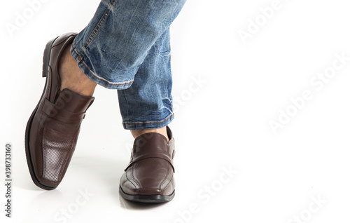 Close up of man leg in jeans with leather shoes