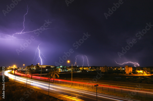 Weather, Lightning thunder storm over city in blue night.