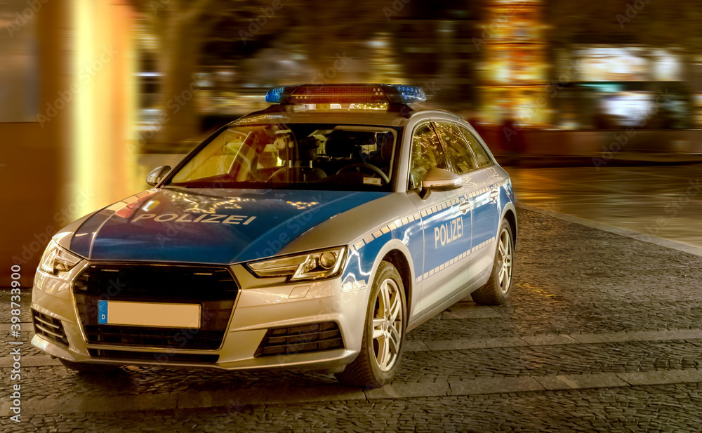Police car in a pedestrian zone to check passers-by due to the Corona pandemic Police car in a pedestrian zone to check passers-by due to the Corona pandemic