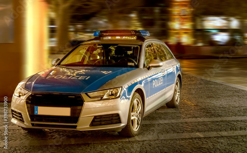 Police car in a pedestrian zone to check passers-by due to the Corona pandemic