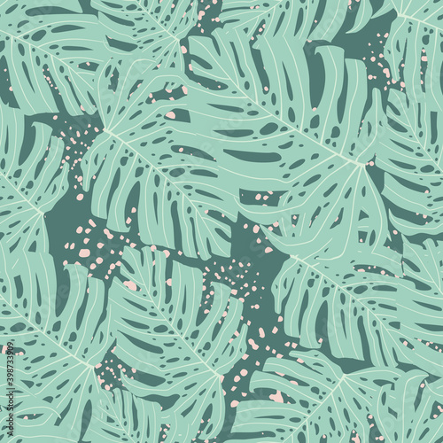 Random seamless pattern with pastel blue monstera shapes. Grey background with splashes.