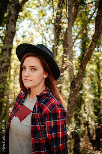 traveler hipster woman standing alone in autumn woods . © selenit