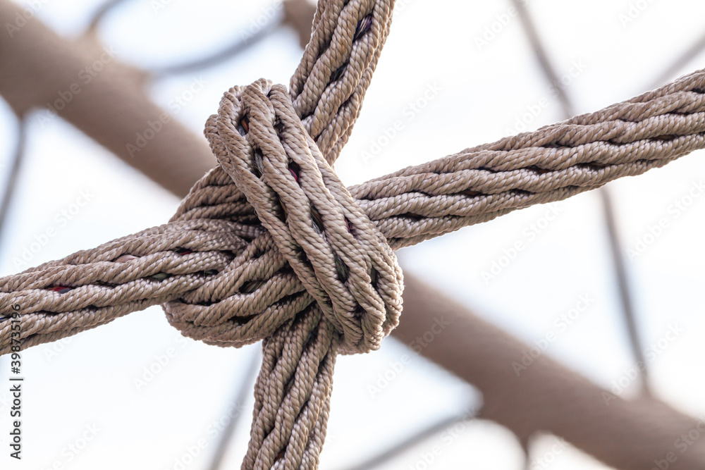 Close-up of rope knot line tied together with playground background Close-up of rope knot line tied together with playground background