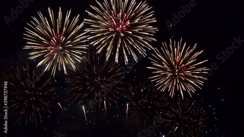 Stunning fireworks show fills the dark night sky with color as dozens of explosions spread across the screen. Shining sparkling pyrotechnic display celebrating an event.
