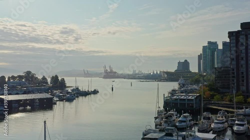 Stunning Drone Aerial Shot Over the Vancouver Marina, Moving Closer to the Cityscape Skyscrapers Canada. photo