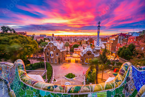 Beautiful sunrise in Barcelona seen from Park Guell. Park was built from 1900 to 1914 and was officially opened as a public park in 1926. In 1984, UNESCO declared the park a World Heritage Site