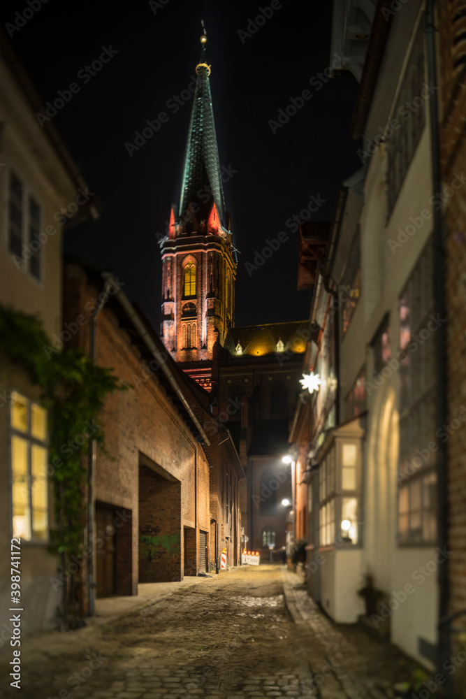 Fototapeta premium Illuminated street in medieval Lueneburg.