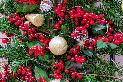 Obraz na plátně A gold ball, with pine cones, pine branches, butcher's broom and lights, used as Christmas decorations