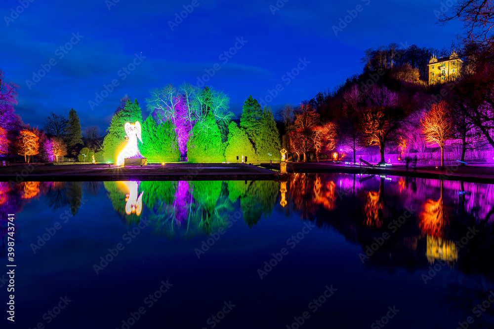 Beautiful illuminated public park next to a christmas market at night in Salzburg, Austria.