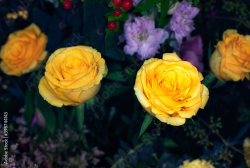 Close-up of a mixed bouquet of roses summer flowers background.