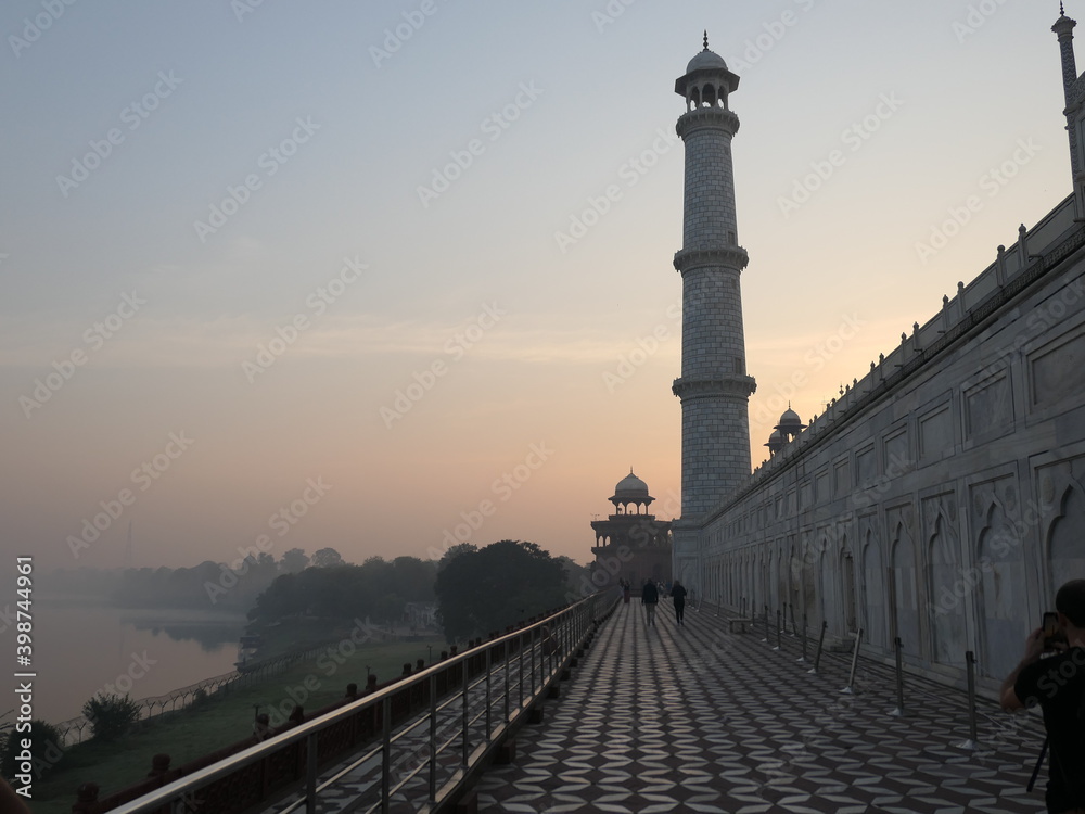 India - Uttar Pradesh - Agra - Taj Mahal - Minaret at Sunset – The Northeast corner Minaret stands 40 meters tall overlooking the Yamuna River against the dusk sky.
