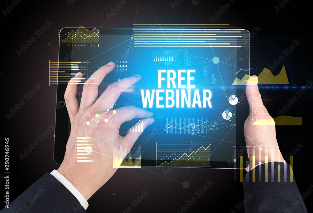 Close-up of hands holding tablet with FREE WEBINAR inscription, modern business concept Close-up of hands holding tablet with FREE WEBINAR inscription, modern business concept
