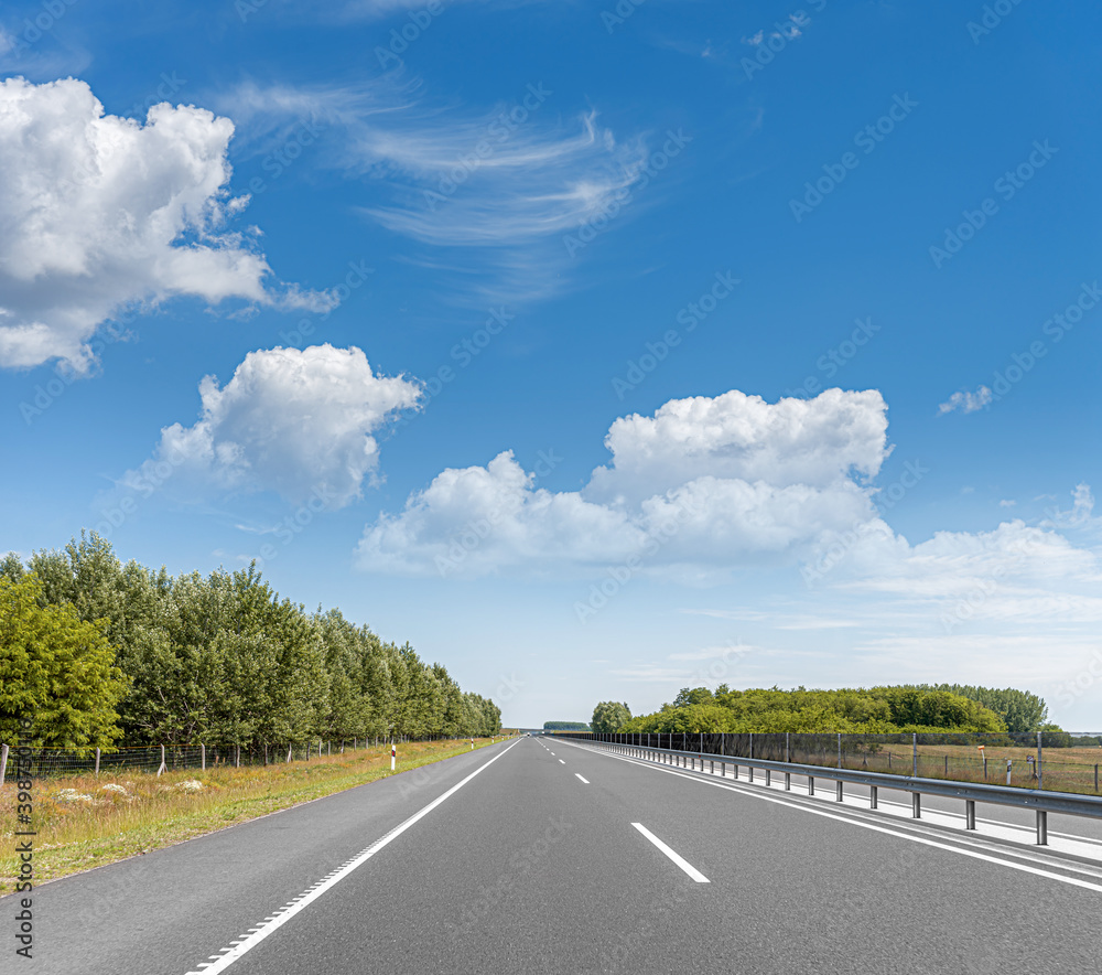 Fototapeta premium Suburban empty high-speed motorway on a sunny day.