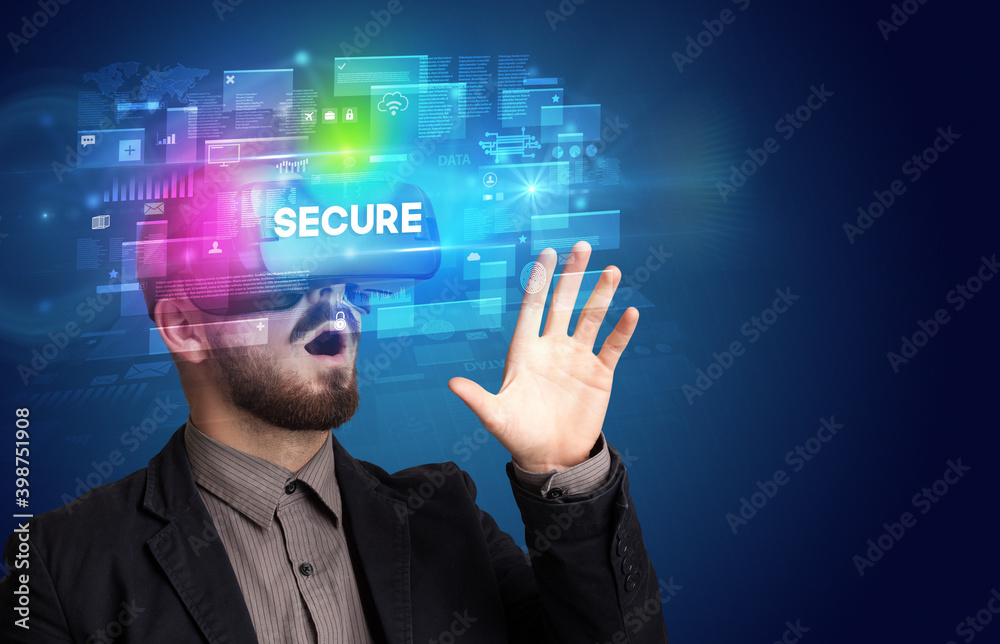 Businessman looking through Virtual Reality glasses with SECURE inscription, innovative security concept Businessman looking through Virtual Reality glasses with SECURE inscription, innovative security concept