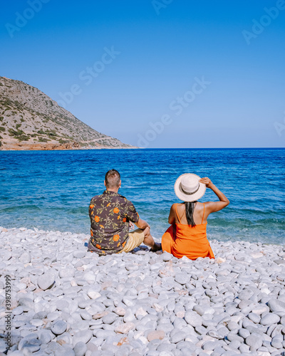 Crete Greece Plaka Lassithi with is traditional blue table and chairs and the beach in Crete Greece. Paralia Plakas, Plaka village Crete, couple on vacation holiday in Greece photo