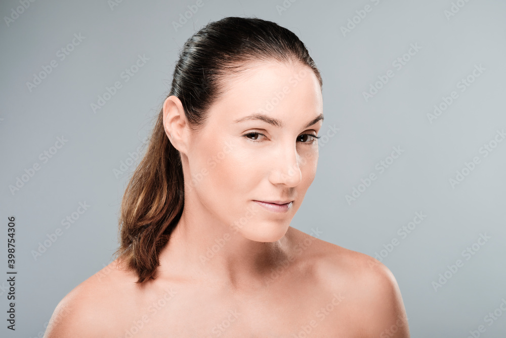 Perfect skin young beautiful woman portrait looking at camera with nude shoulders Perfect skin young beautiful woman portrait looking at camera with nude shoulders