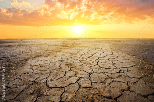 dry cracked earth at the dramatic sunset, ecologigal calamity background Fototapet