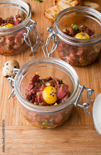 Steak tartare. Classic American restaurant or French bistro appetizer classic. Steak diced, mixed with eggs, red onions, olive oil, lemon juice, garlic and capers. Served with garlic bread.