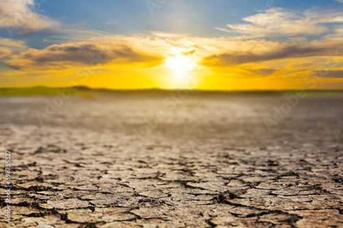 dry cracked earth at the dramatic sunset, ecologigal calamity background